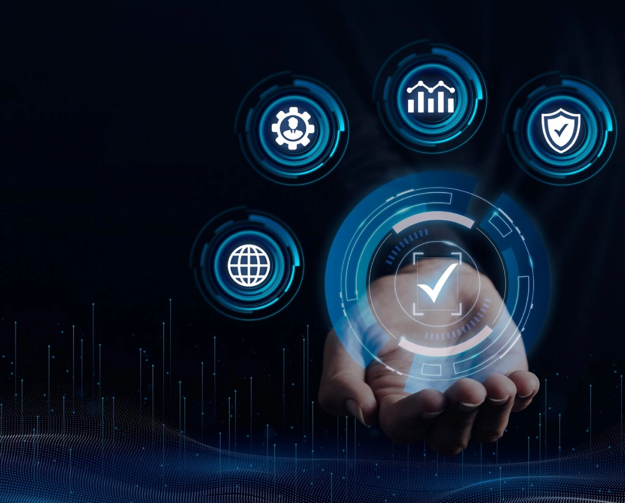 A hand holds a glowing interface featuring icons for gear, graph, globe, shield, and checkmark, symbolizing digital solutions and security. A hand holds a glowing interface featuring icons for gear, graph, globe, shield, and checkmark, symbolizing digital solutions and security.